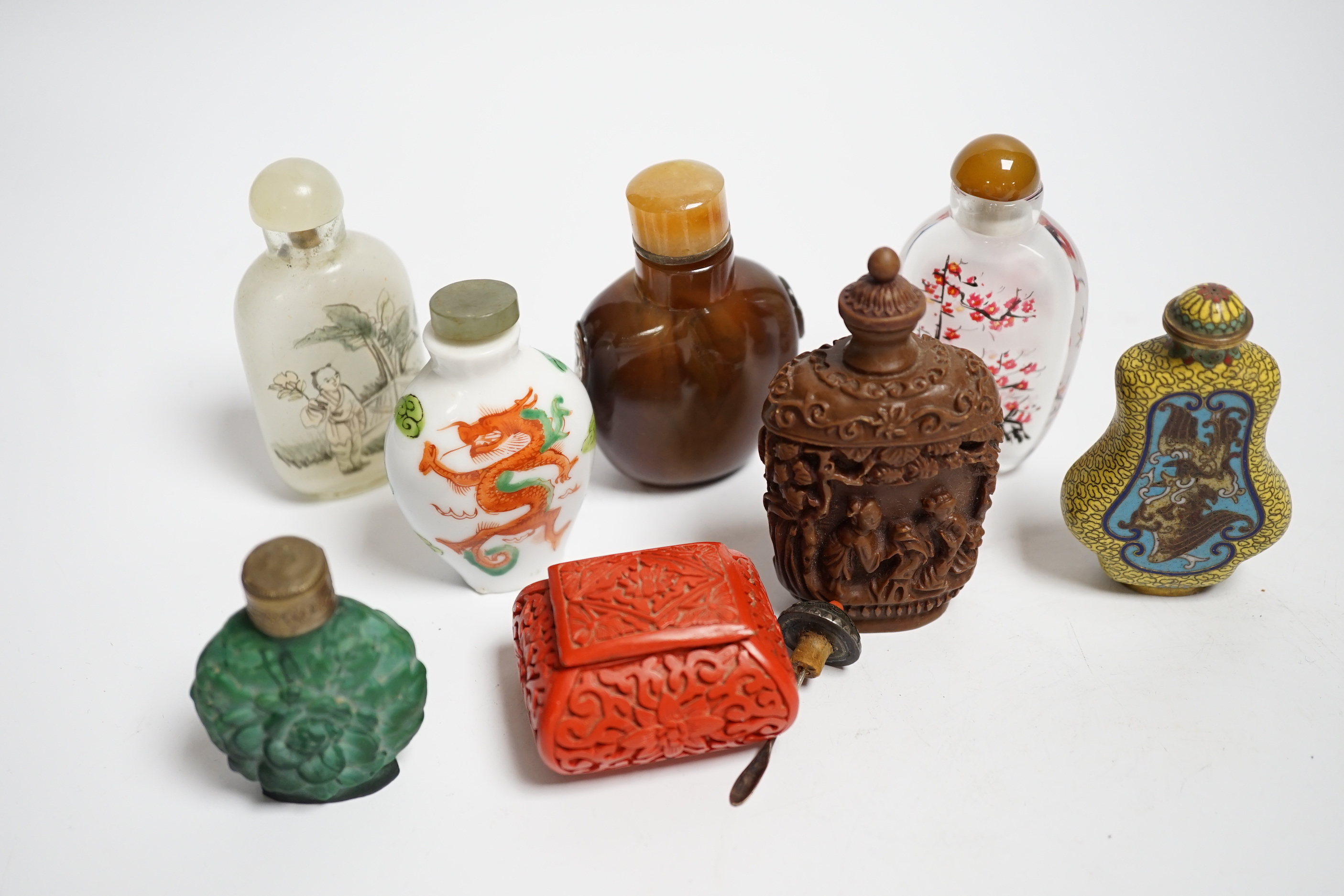 Seven various snuff bottles to include agate, glass, cloisonné and resin together with a lacquer snuff box (8)